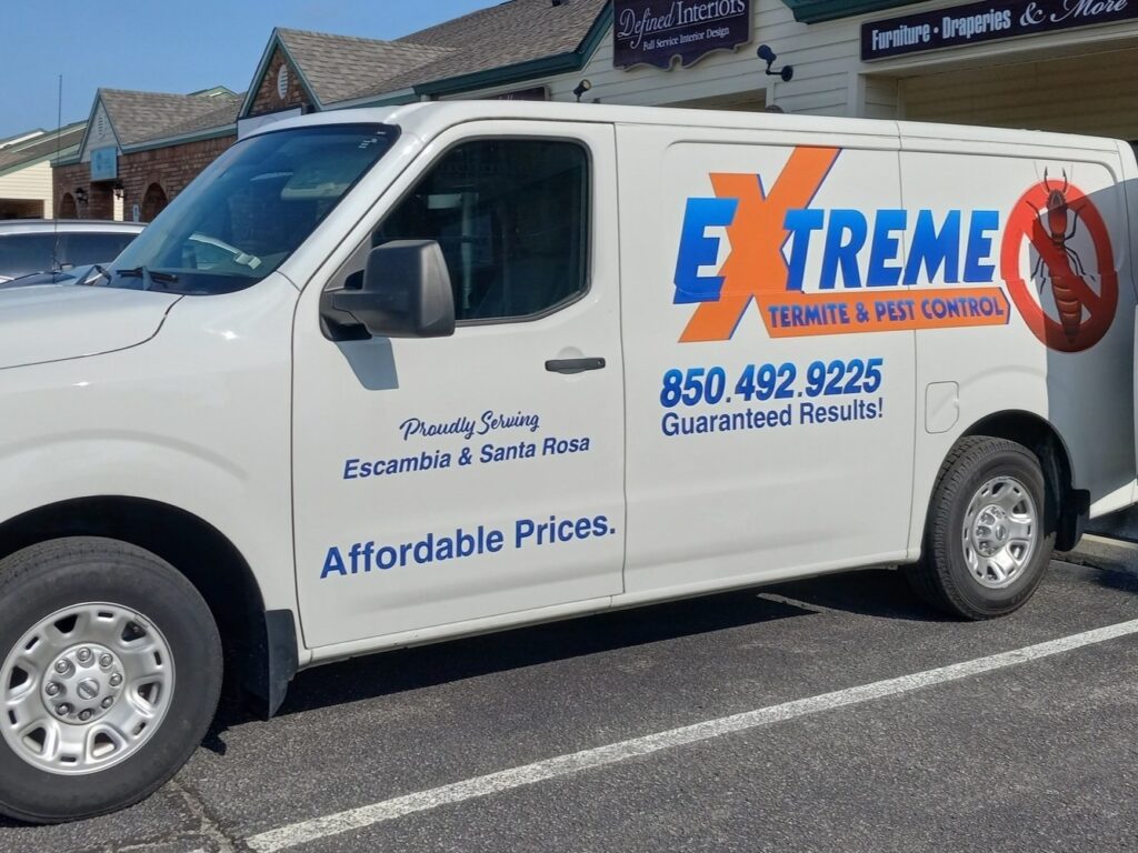 Extreme Termite and Pest Control truck parked outside of a commercial building in Pensacola Florida.